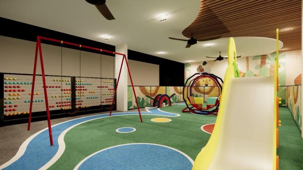 Colourful indoor playroom with safety surfacing, swings, and activity equipment.
